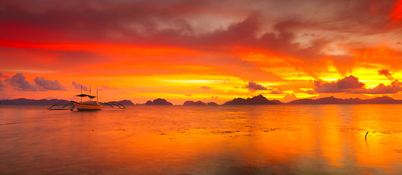Boats at sunset. Panorama