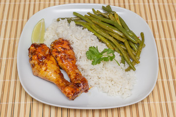 Indonesian chicken drumsticks with rice, lime and sajoer beans