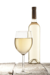 Wineglass and bottle with white wine