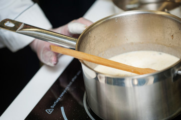 Pans in the kitchen, the cook hands.