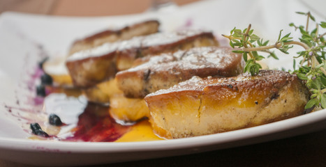 Foie gras with berries and pineapple close up