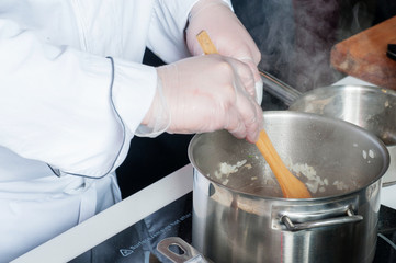 Pans in the kitchen, the cook hands.