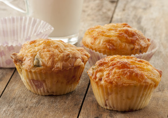 savory muffin with ham and cheese on wooden background