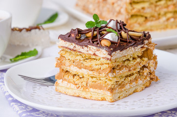 Cake with caramel cream, meringue and 
peanuts