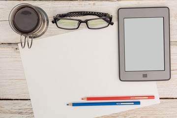 View from the top: white sheet of paper and coffee