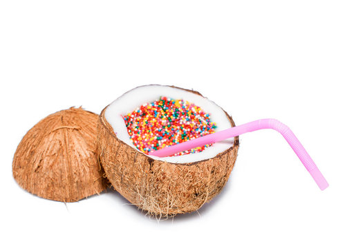 Sweet Coconut Cocktail Isolated On White. Coconut With Rainbow Sprinkles Inside. Sugar Sprinkle Dots At The Coconut. The Concept Of Food Porn.