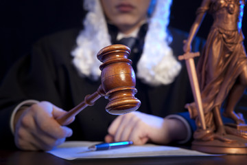 Male judge in a courtroom striking the gavel