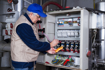 electrician at work with an electric panel
