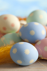 Colored Easter eggs on blue sky background