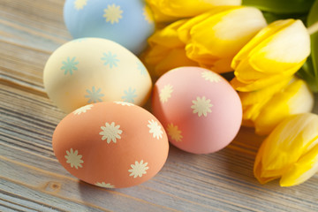 Four Easter eggs and flowers
