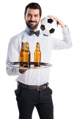 Waiter with beer bottles on the tray holding a soccer ball