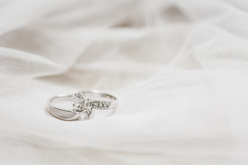 two wedding rings on white cloth