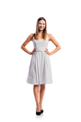 Naklejka premium Girl in black-and-white dotted dress, heels, studio shot, isolat