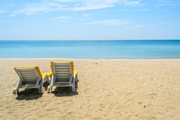 Fototapeta na wymiar Beach chairs on White Sand Beach with blue sky in Phuket,Thailand