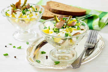 Salad with meat, pickles, potatoes and mushrooms.