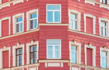 Fototapeta na wymiar Several windows in row on corner of facade of urban apartment building front view, St. Petersburg, Russia.