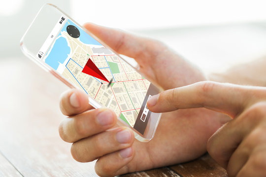 close up of hand with navigator map on smartphone