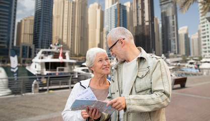 happy senior couple with city map over harbor