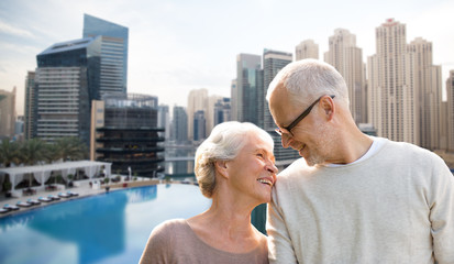 senior couple hugging over dubai city waterfront