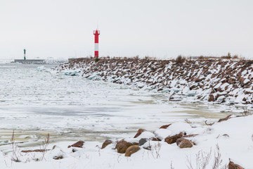 Lighthouse on the shore of the Gulf of Finland in winter scene.