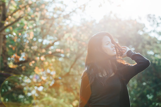 Happy woman enjoying with nature light. Freedom concept with bea