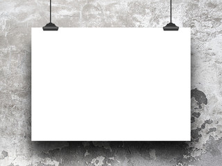 Close-up of one hanged horizontal paper sheet with clips on weathered concrete wall background