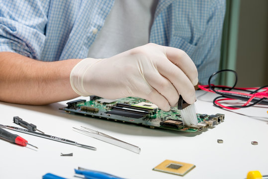 Electronic technician reparing computer board