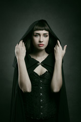 Beautiful pale woman with black cloak