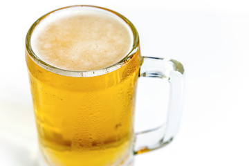 Frosty glass of light beer on a white background