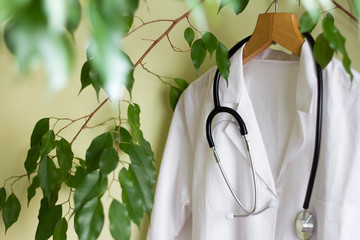 Alternative medicine concept with green tree and doctor coat
