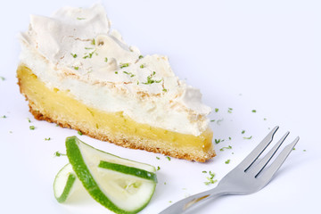 isolated piece of lemon meringue pie, tart, decorated with lime