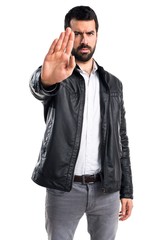 Fototapeta premium Man with leather jacket making stop sign