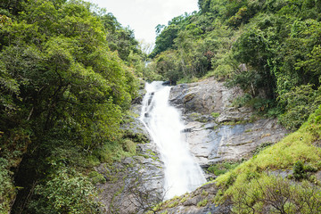 Fototapeta na wymiar Wonderful green waterfall in deep forest at national park, Thailand