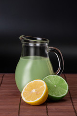 lime, lemon and pitcher of juice