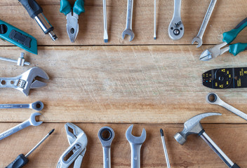 Many tools on old wooden panel