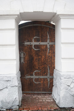 close up old wooden door with metal loops