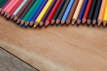 Closed up color pencil with wooden background
