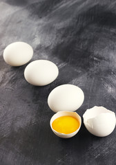 Raw eggs against a dark background