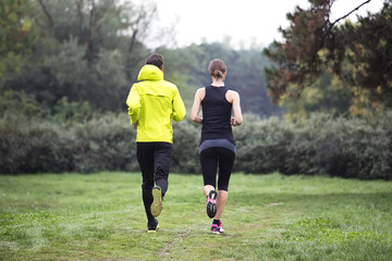 Fototapeta premium Young couple running in the park