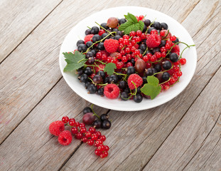 Fresh ripe berries on wooden table