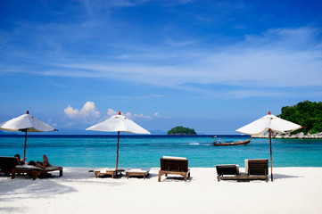 Fototapeta premium Beach chair and umbrella on sand beach
