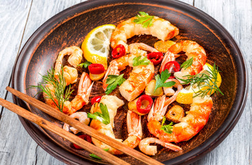 shrimp tails, stir fried in olive oil with spices, close-up