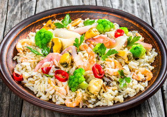 wild rice with seafood and broccoli in a bowl, close-up