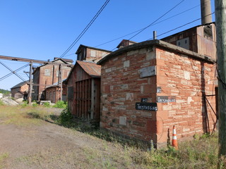 Abandoned brick structures with "no trespassing" sign - landscape color photo