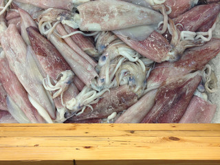 Wood table layout for your products and Many squid freezing