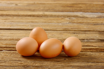 Brown eggs on wooden surface