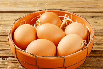 Brown eggs in terracotta bowl