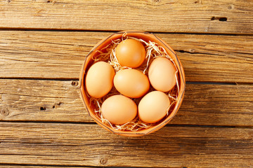 Brown eggs in terracotta bowl