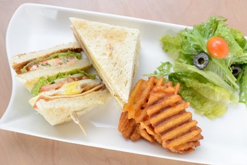 Freshly made club sandwiches served with potato chips