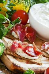 Snack sandwiches with dried ham, sauce, cottage cheese on rye cr